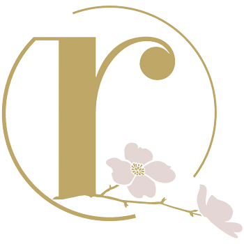 Rejuvenation Center logo. gold "r" surrounded by circle and dogwood blossom at bottom.